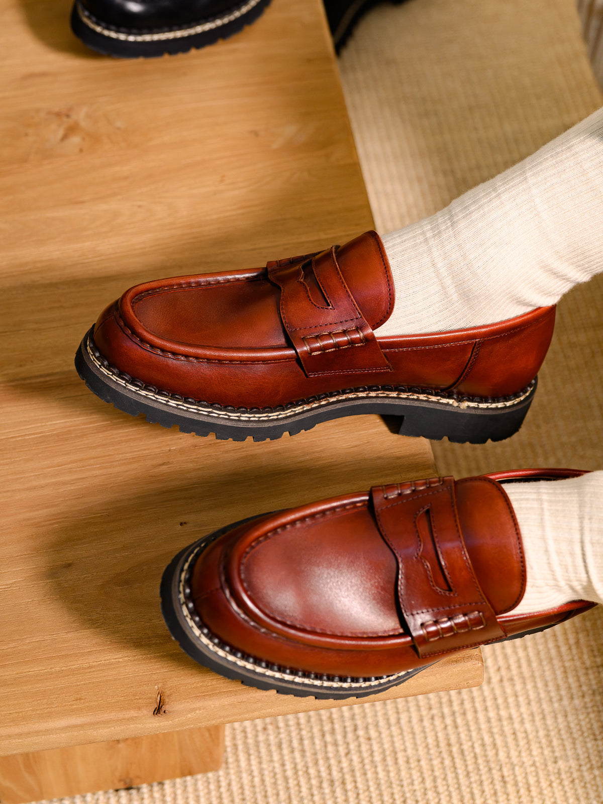 Paper Straight Atlas Loafer Rust — pair worn, close-up of the welt stitching