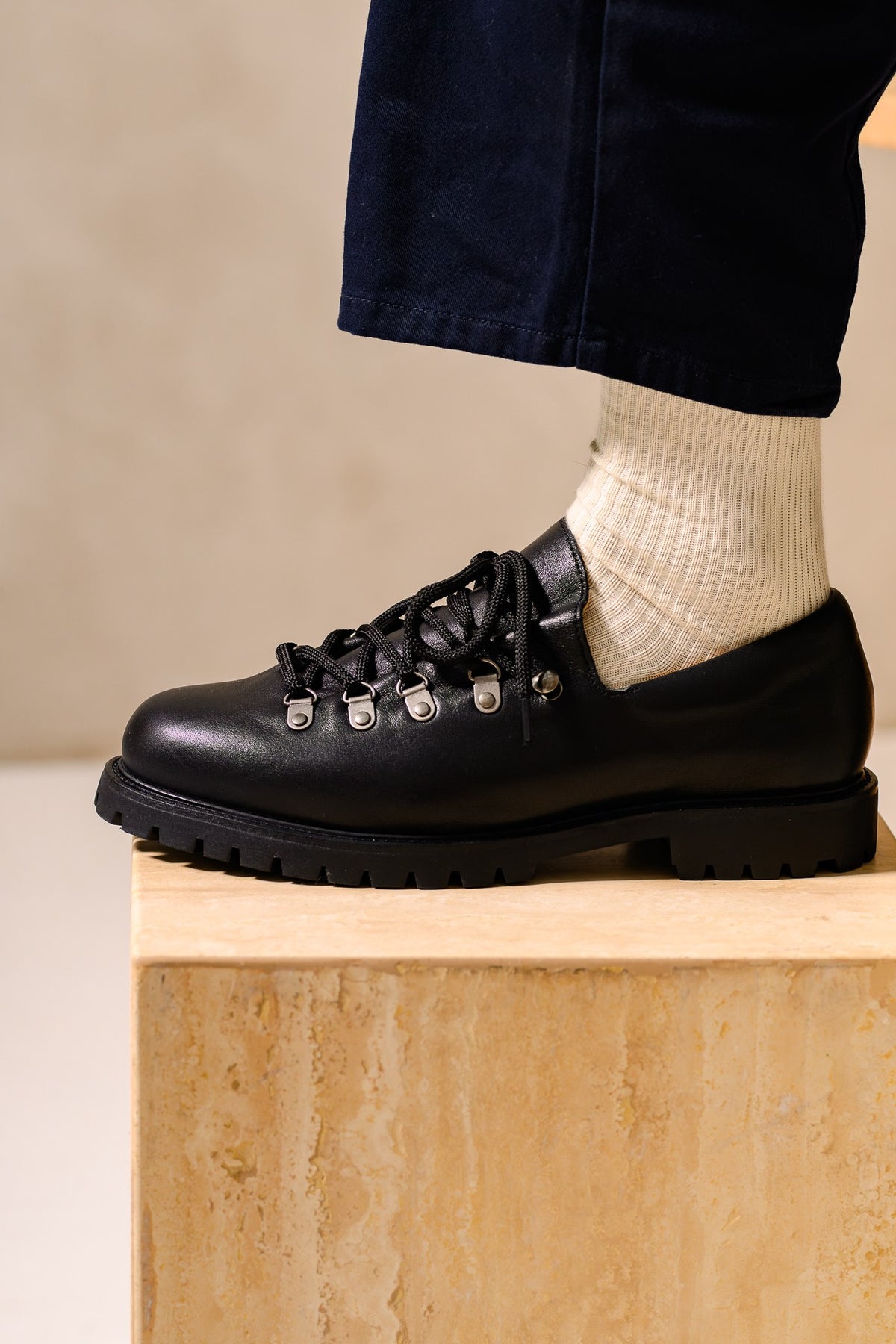 Paper Straight Heritage Derby in black leather worn with navy trousers