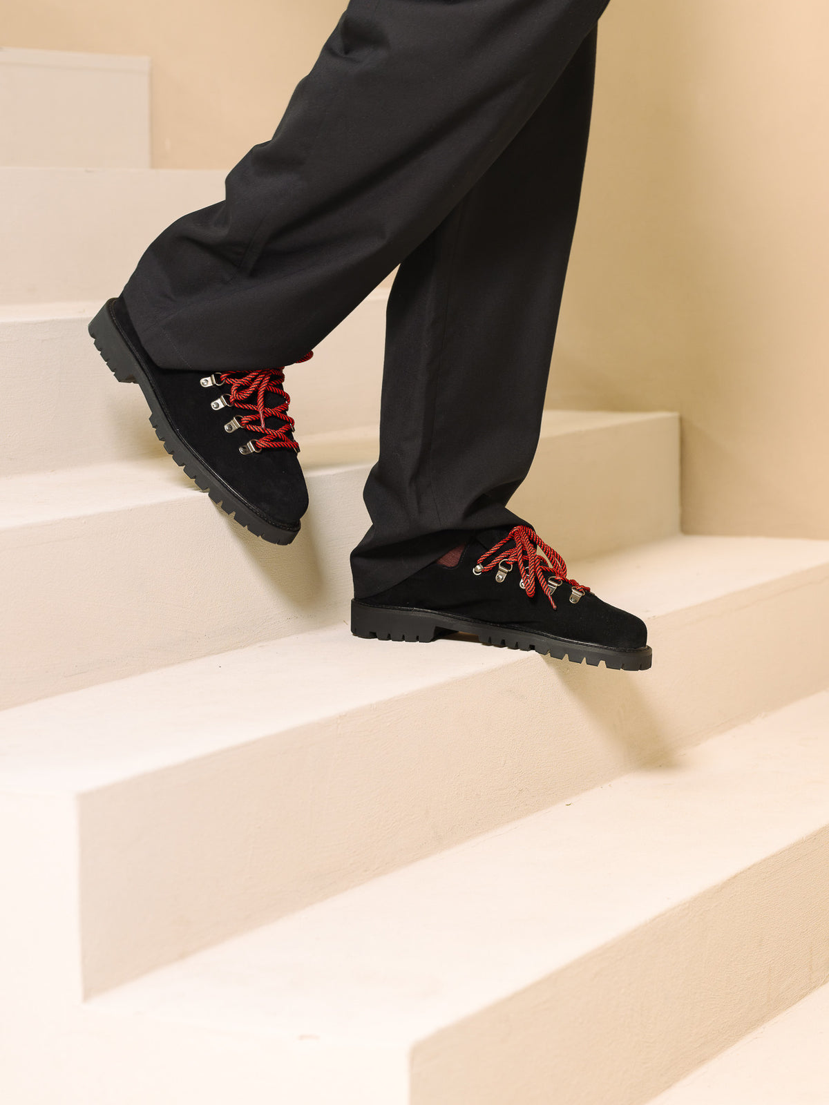 Paper Straight Heritage Derby Black Suede — worn, stepping down a staircase