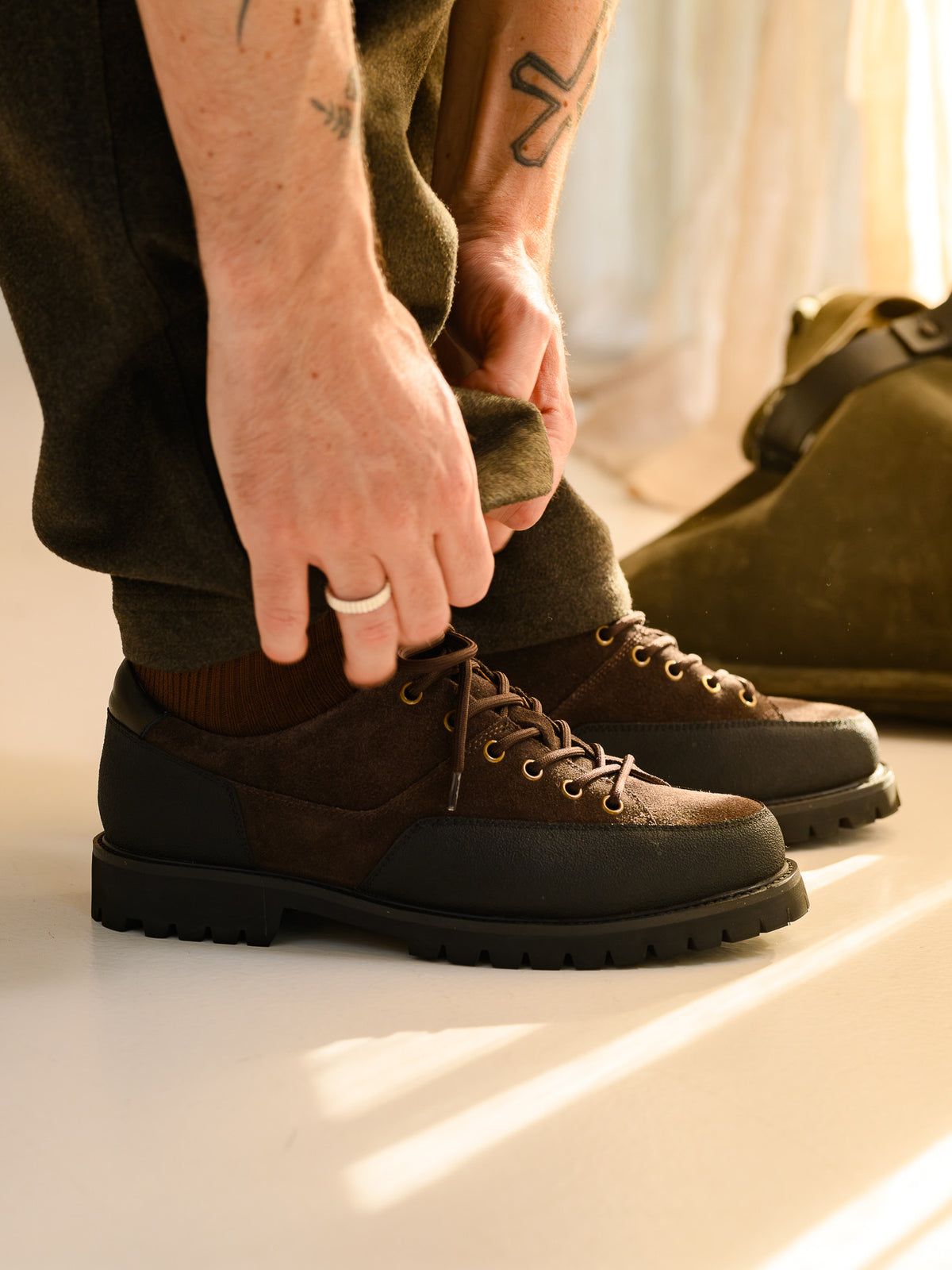 Paper Straight Ridgeworks Low Coffee — worn, trouser leg pulled up