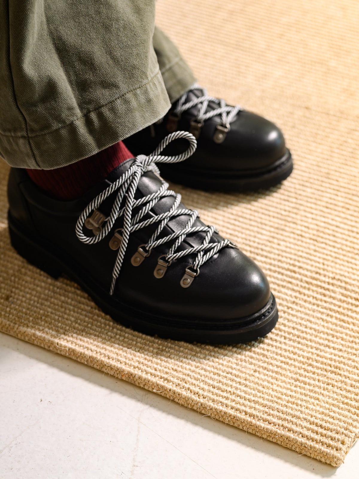 Paper Straight Summit Derby Signature black — worn with olive trousers on a jute rug