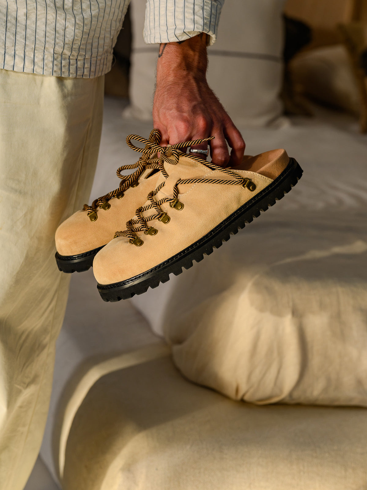 Paper Straight Summit Mule Beige — pair held in one hand, side profile
