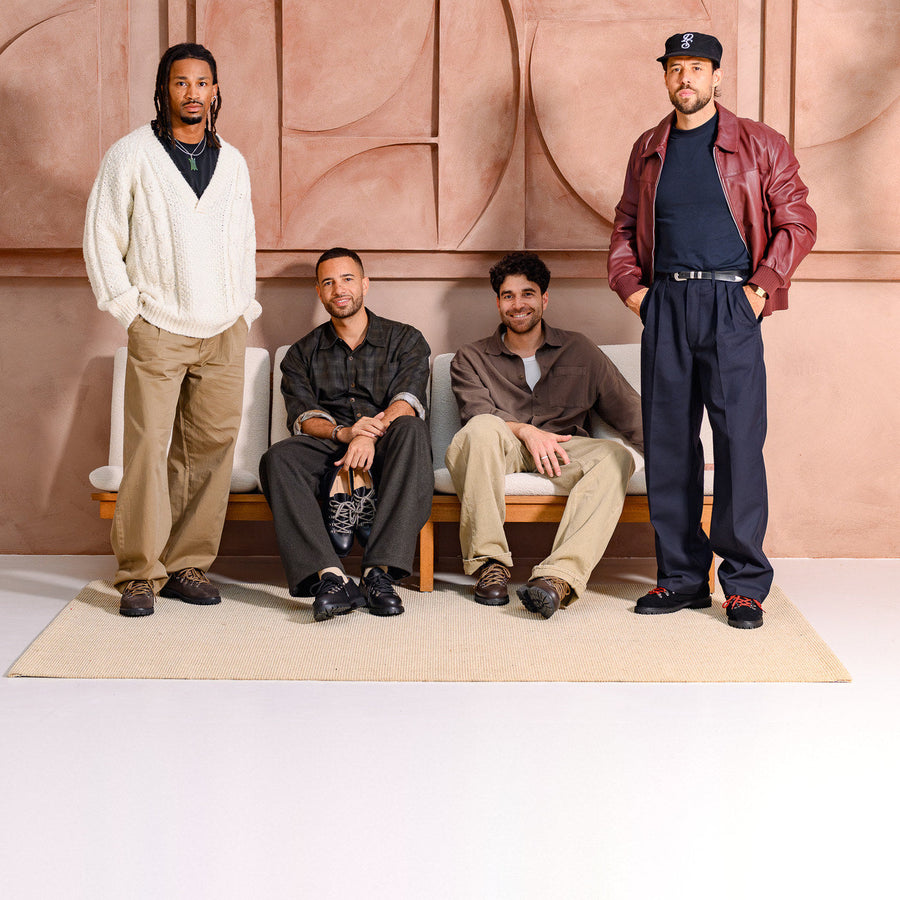 Four men in Paper Straight Autumn Winter 26 footwear, two standing and two seated on a bench