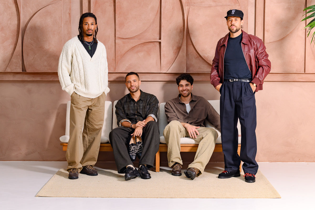 Four men in Paper Straight Autumn Winter 26 footwear, two standing and two seated on a bench