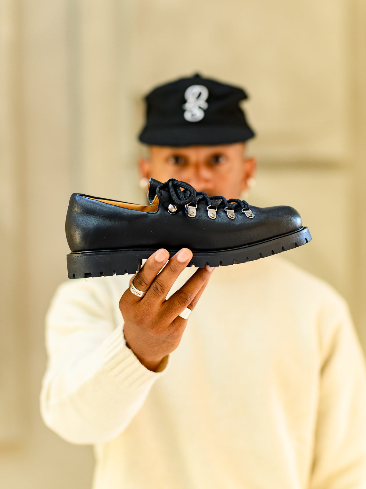 Paper Straight Heritage Derby Leather Black — held up to the camera