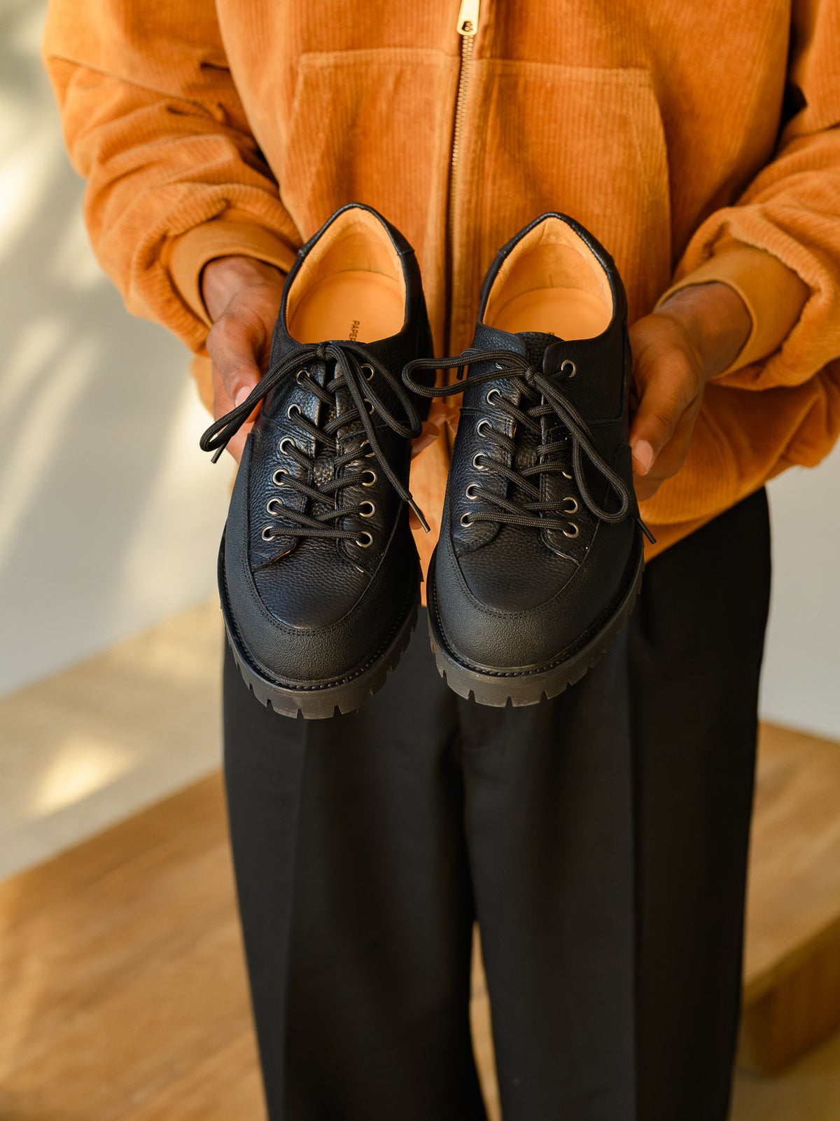Paper Straight Ridgeworks Low Black — pair held in both hands