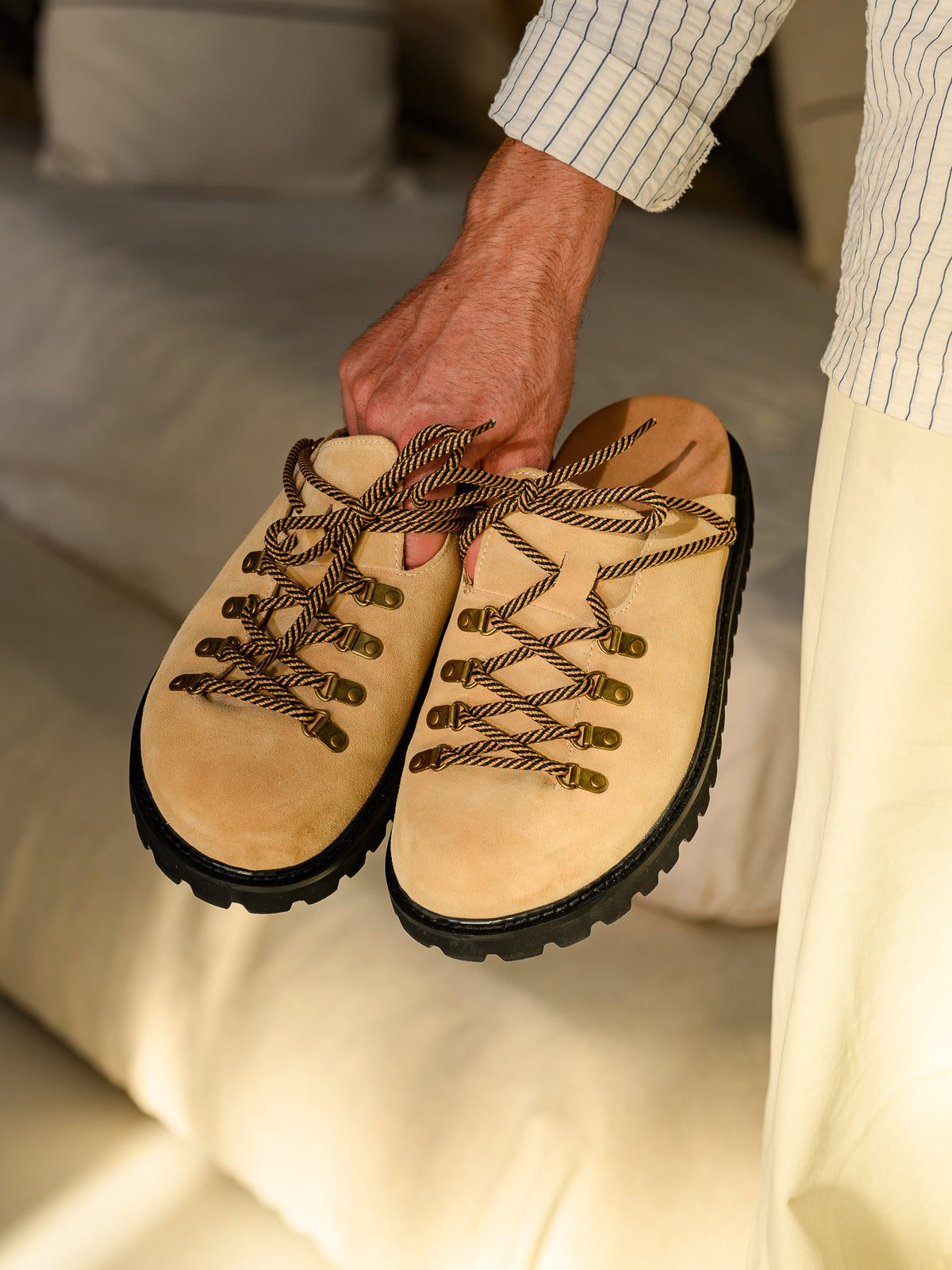 Paper Straight Summit Mule Beige — pair held in one hand, front view
